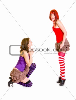 Cute girl on knees begging her shocked girlfriend
