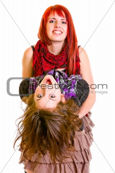 Two jaunty young girlfriends funny embracing
