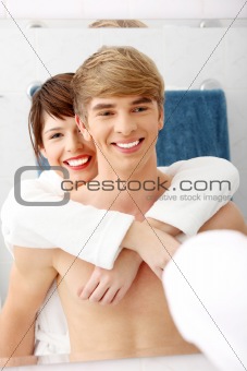 Young happy couple at bathroom.