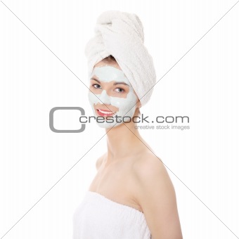 Cosmetics mask of clay on the beautiful young woman face