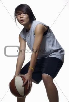 Asian teen female basketball player in defensive stance