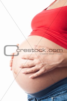 Pregnant woman holding her belly with hands