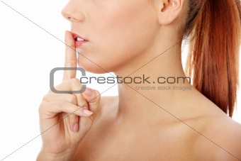Young woman gesturing for quiet