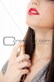 Beautiful woman applying perfume