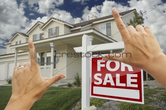 Female Hands Framing Home For Sale Real Estate Sign in Front of New House.