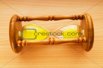 Time concept - hourglass against the wooden background