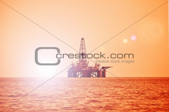 Offshore oil rig during sunset in Caspian sea