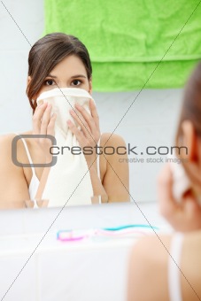 Beautiful woman wipes her face