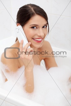 Beautiful young woman talking by phone