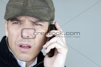 Worried Man In Newsboy Hat On Phone