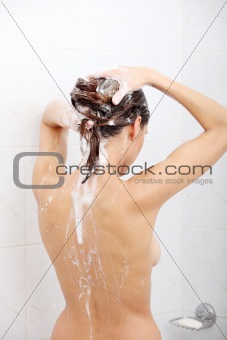 Young pretty woman taking shower 
