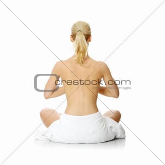 Young beautiful nude blond woman meditating