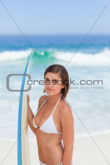 Cute woman with her surfboard