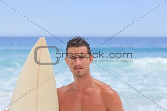 Man posing with his surfboard