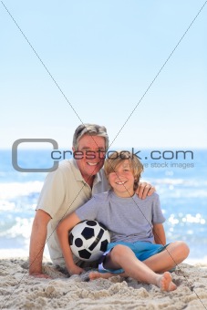 Grandfather and his grandson with a ball