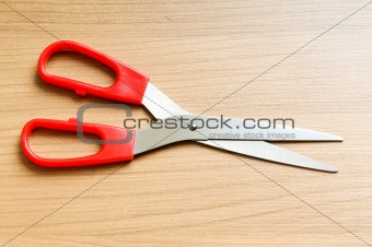 Various scissors on the wooden background