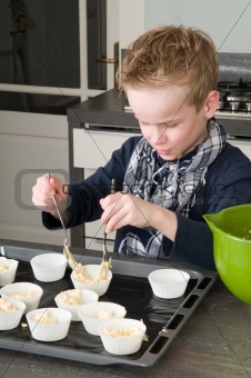 Kid Filling Cake cups With Dough
