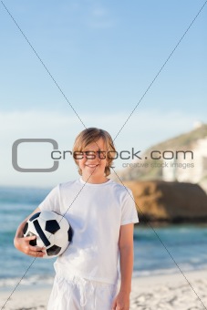 Little boy with a ball on the beach