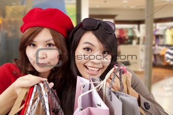 Two happy girls in a shopping center