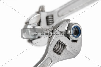 The image of a wrench with a nut, isolated, on a white backgroun