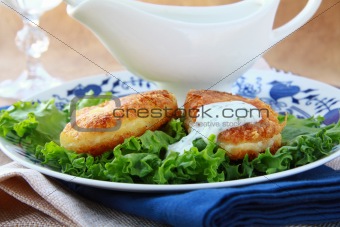 potato patties with green salad and yoghurt sauce