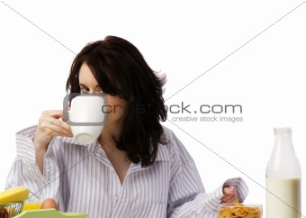 young woman at breakfast drinking coffee