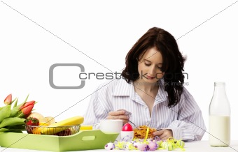 young woman at breakfast eating corn flakes