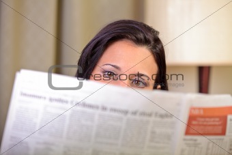 View of woman's eyes reading the newspaper