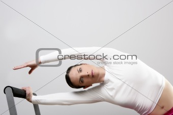 gym woman pilates stretching sport in reformer bed