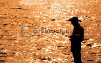 Lone fisherman during late hours of sunset