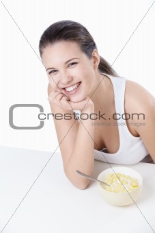 Laughing girl with a bowl of cereal