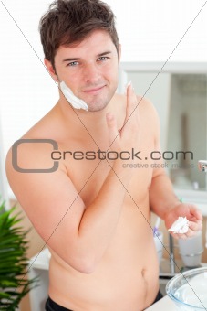 Attractive caucasian man ready to shave in the bathroom