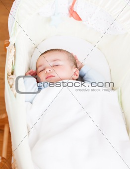 Close-up of an adorable baby sleeping in his cradle