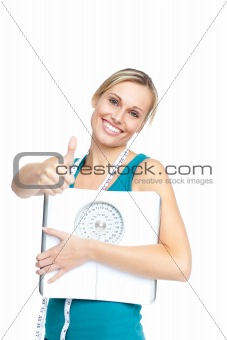 Attractive young woman holding a weight scale