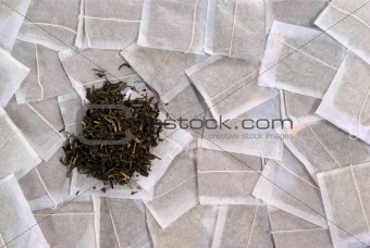 Teabags with green tea pile