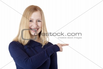 Young beautiful blond woman shows with finger on ad space