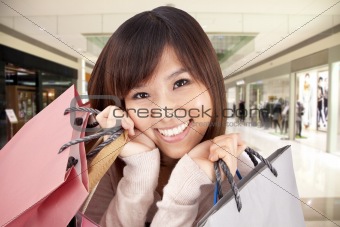 happy asian woman in a shopping mall