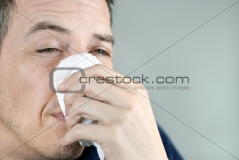 Man Holding Tissue On Nose