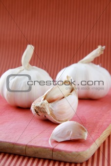 cutting garlic close up shoot on a red background