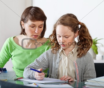 Girl doing prework with her mom