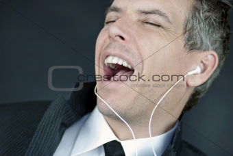 Businessman Wearing Headphones Sings