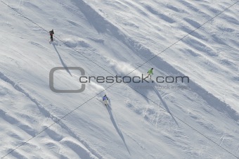 three skiers