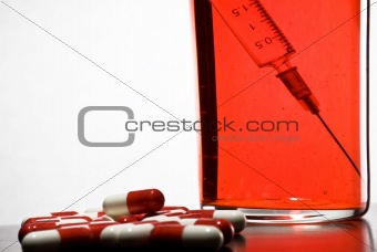 Tablets, a syringe into a glass