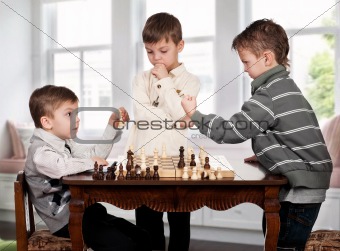 Twin brothers playing chess game