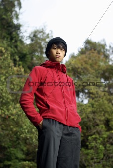 Confident asian man outdoors in red, vertical portrait