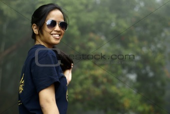 Happy asian malay teen lady with sunglasses outdoors