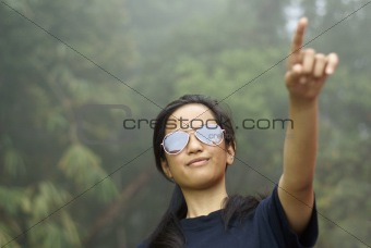 Confident asian malay girl pointing up