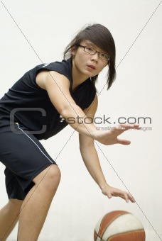 Fit asian basketball player defending ball