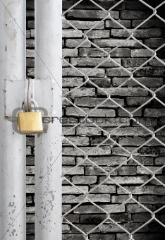 Chain link fence and metal door with lock see grunge wall background