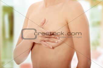 Woman examining her breast